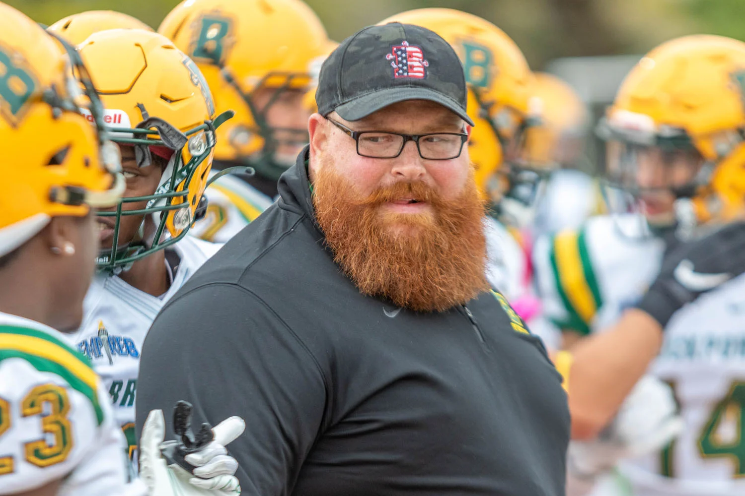 Coach Jaskulski talking to memeber of the team along the sidelines