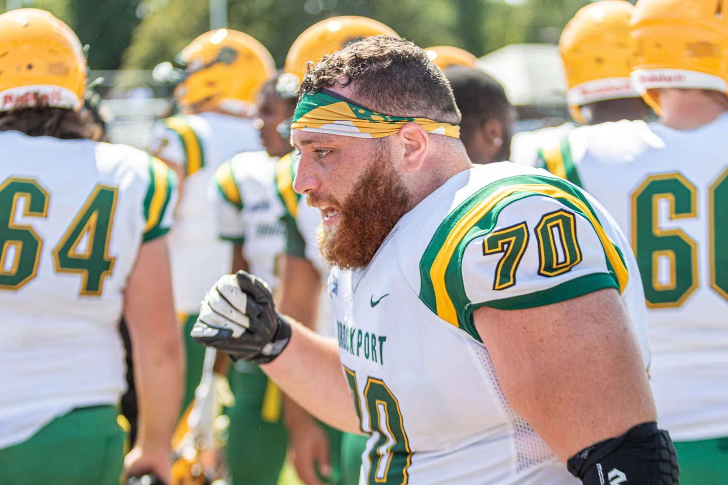 Offensive Lineman chatting up his teammates on the sidelines