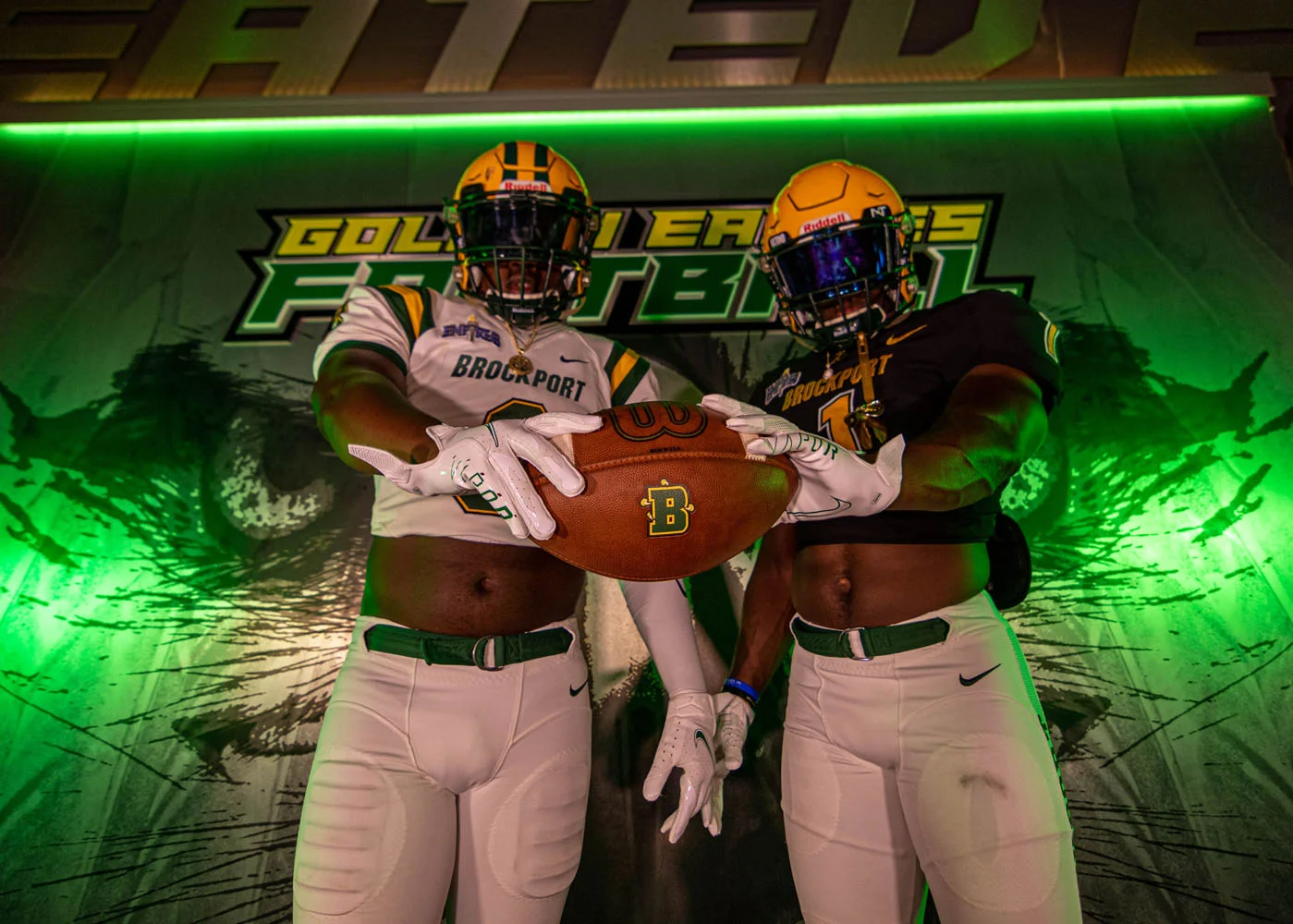 Holding the ball showing off the Brockport logo