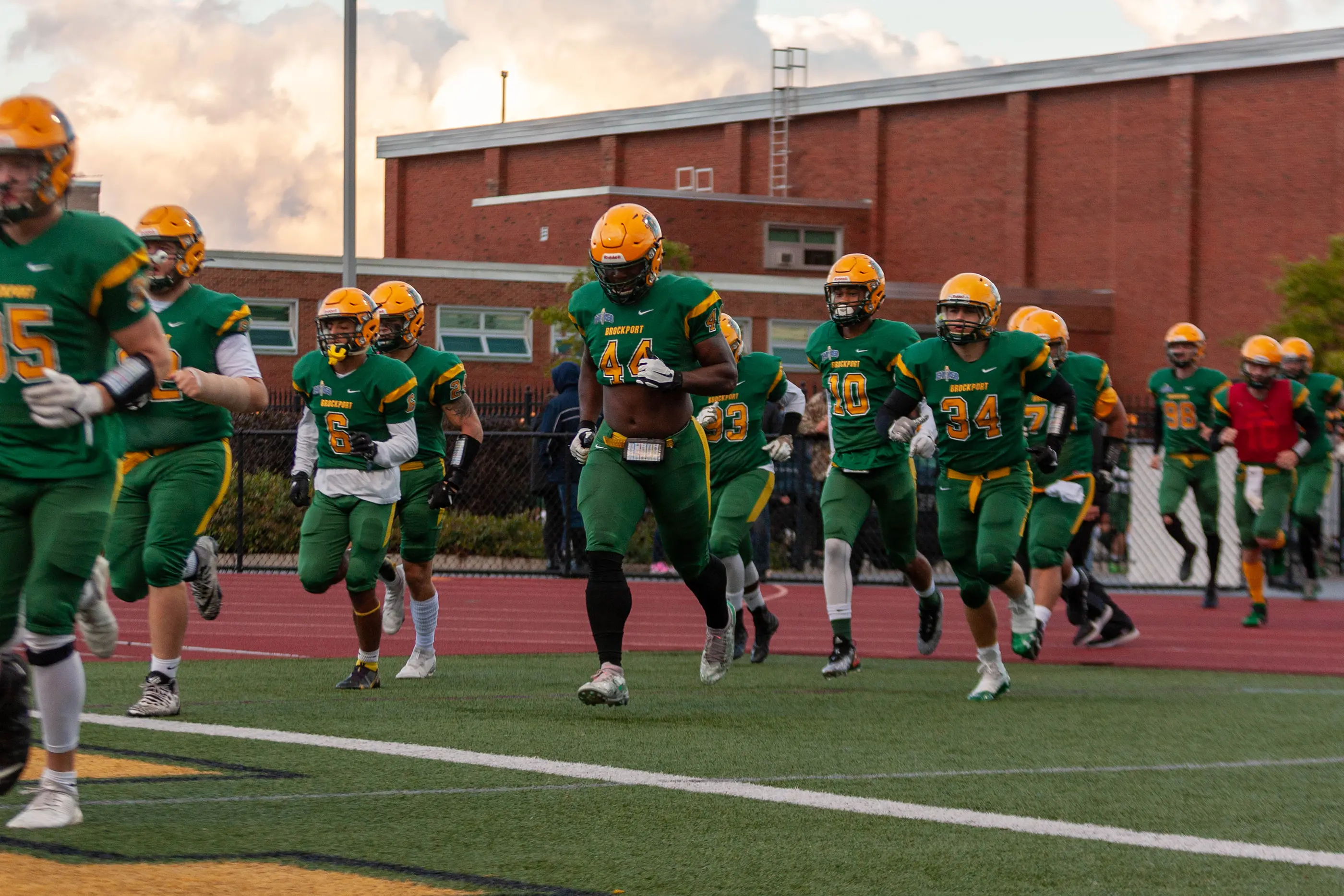 Brockport running onto the field to play Utica