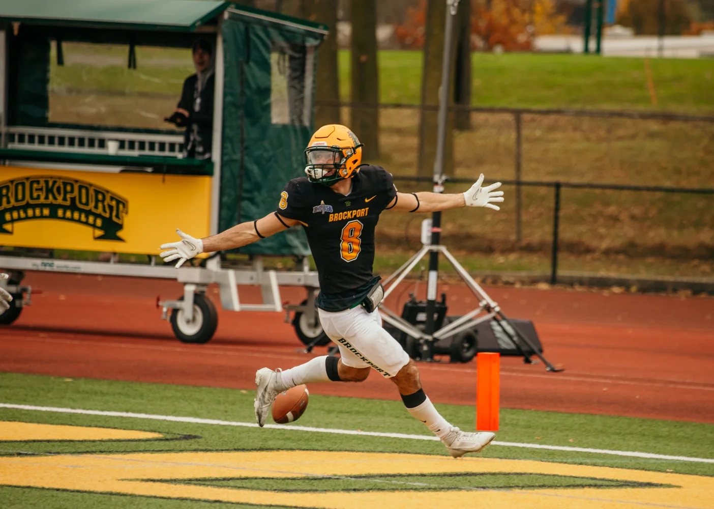 Brockport Defender arms out after scoring a TD