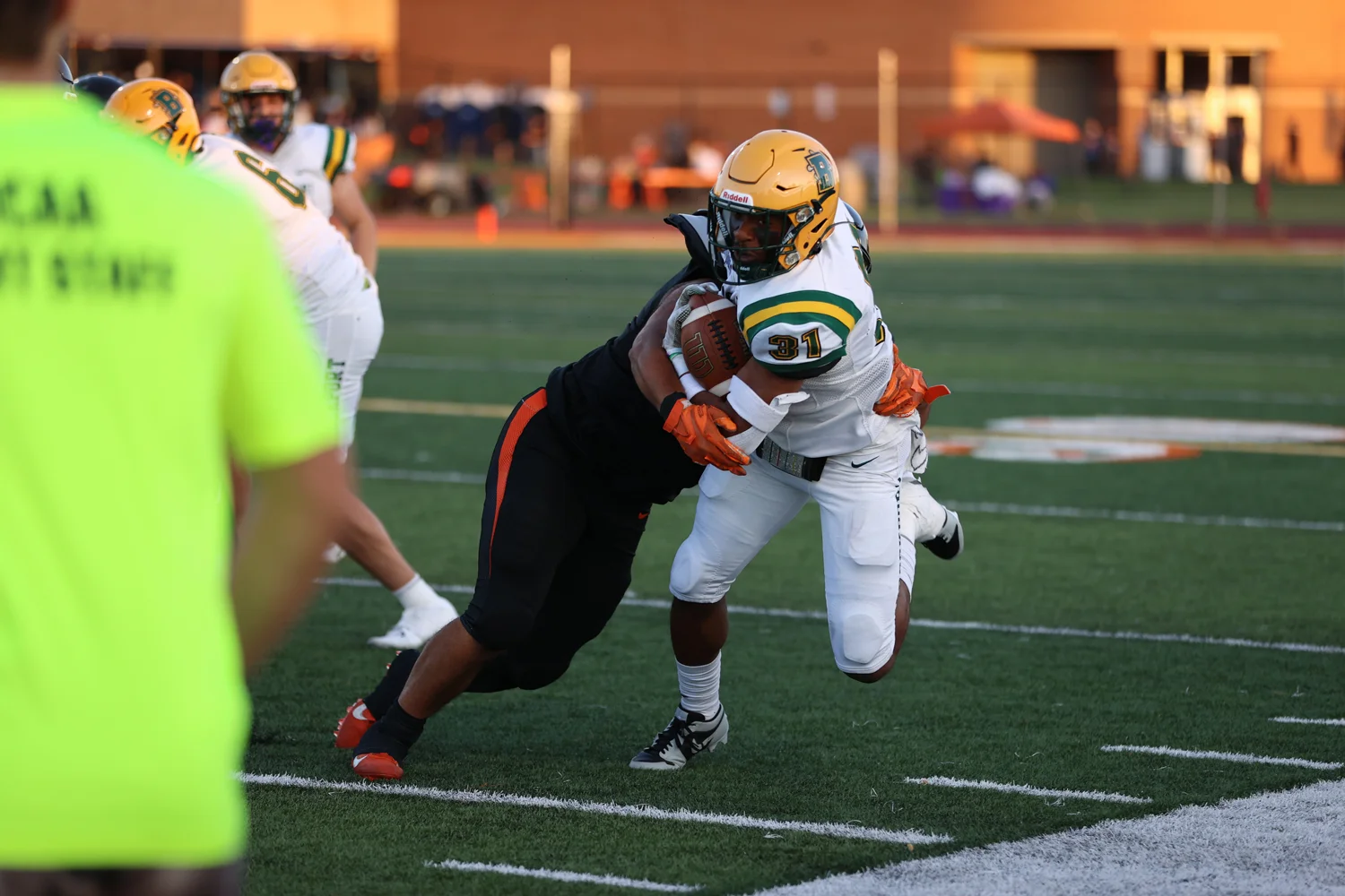 RB reaching for more yards along the sidelines