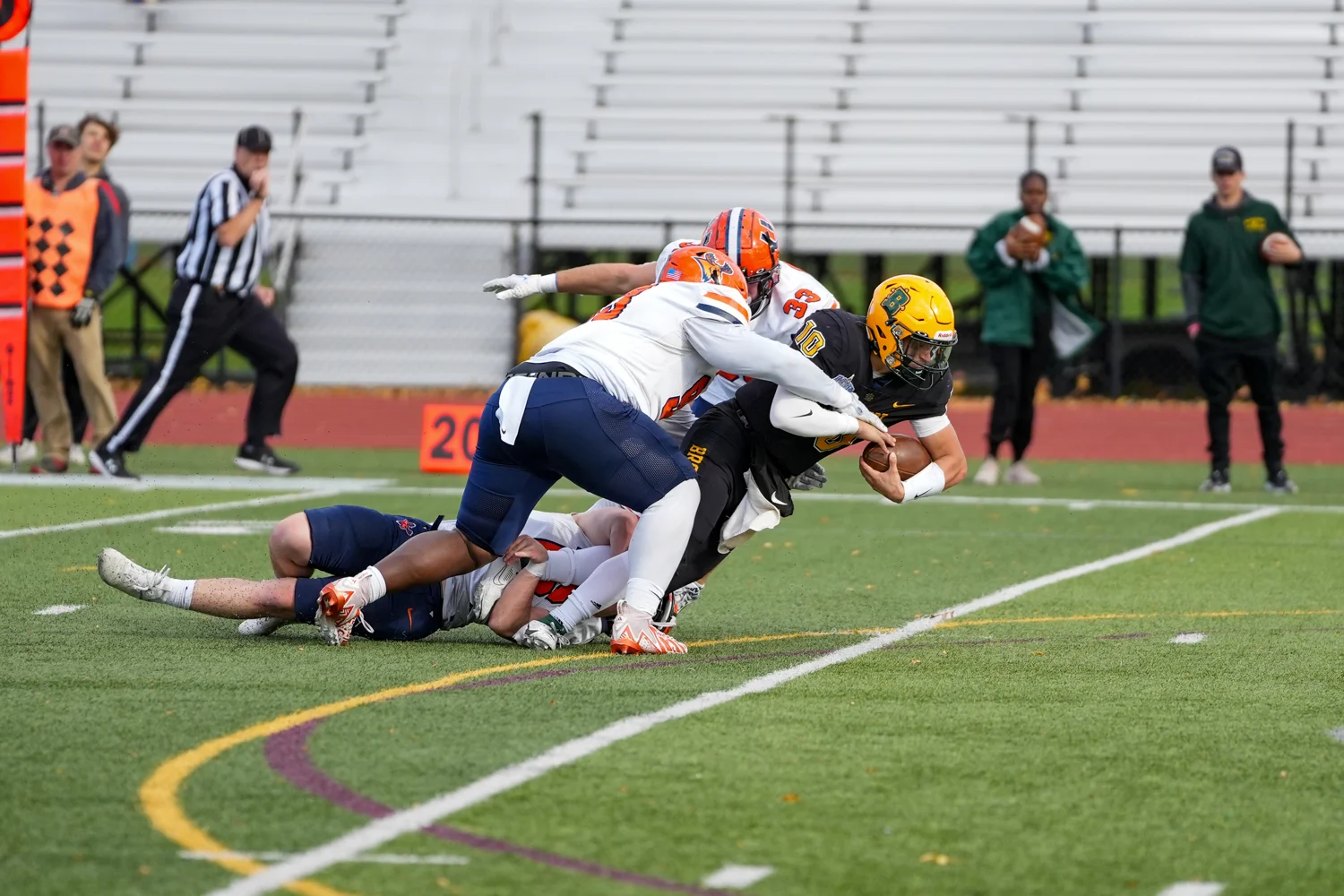 QB stretching to gain yards while getting tackled