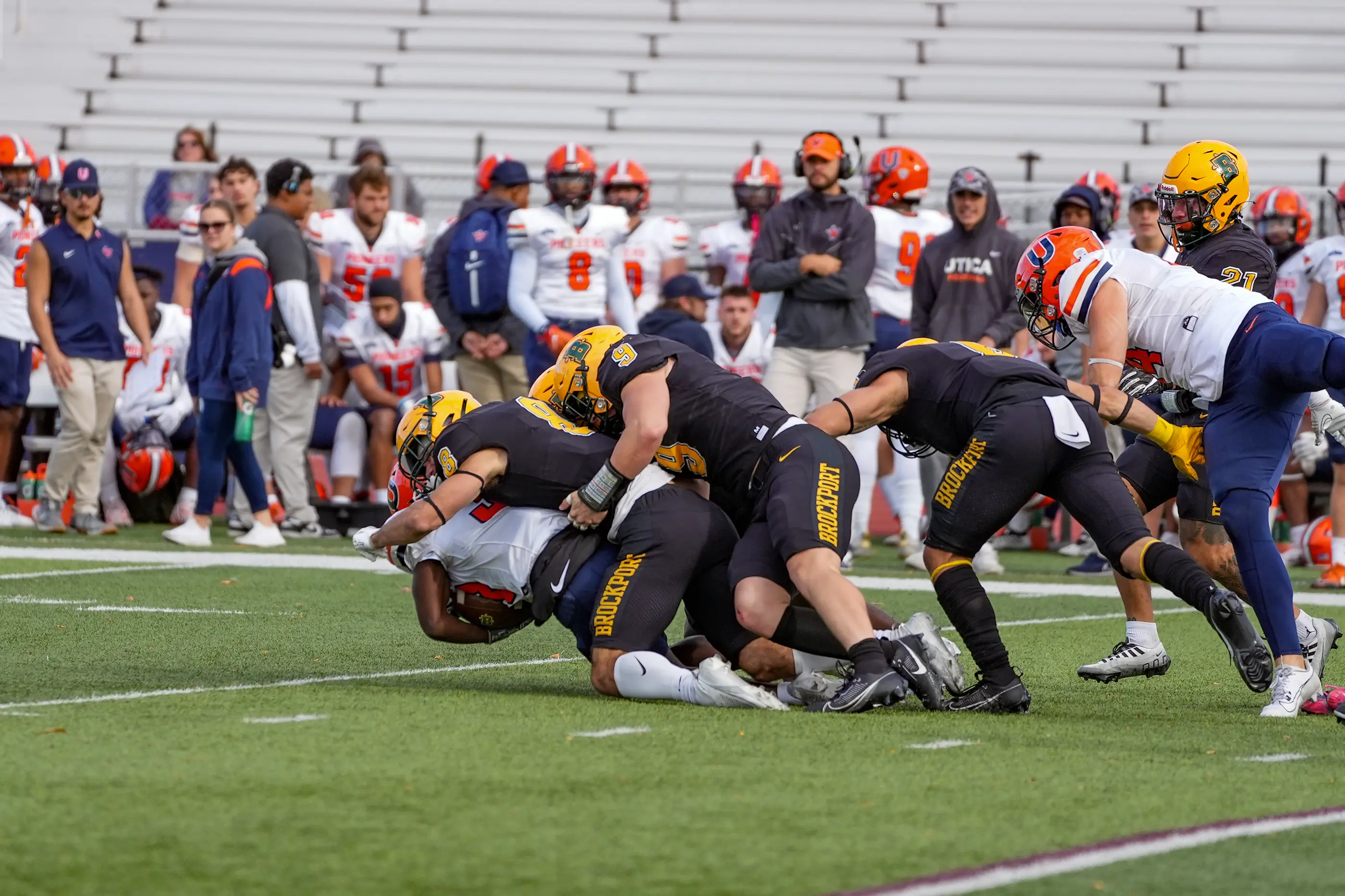 Brockport Football making the gang tackle against Utica
