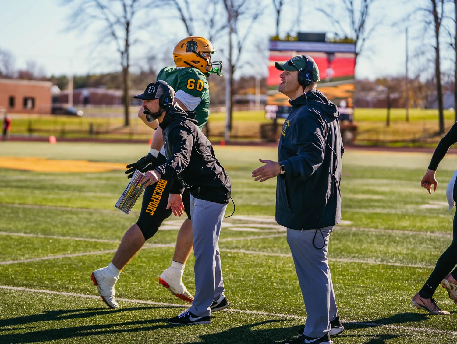 Brockport coaches greeting the team as they come off the field