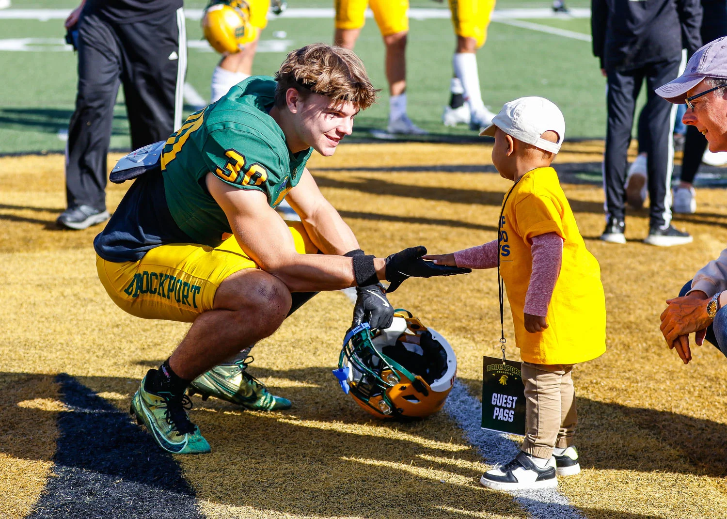 Brockport Player slapping hands with the captain